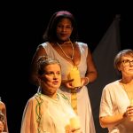 five women dressed in white on stage representing overlooked women from greek mythology. All as part of new theatre show Heroines